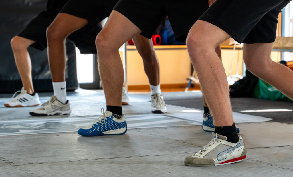 fencers during footwork training in a fencing venue